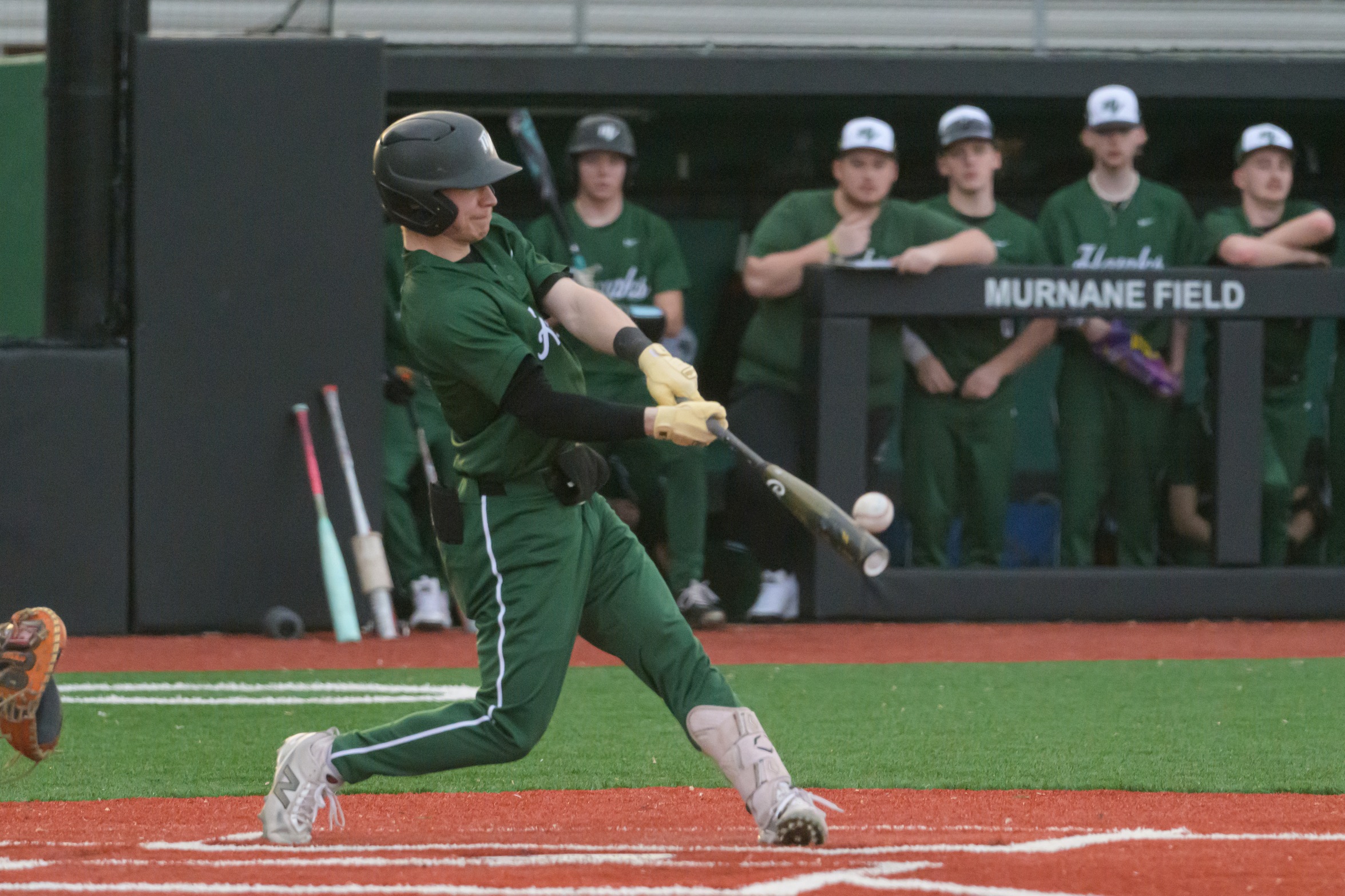 Hawks player connecting with a baseball while at bat.